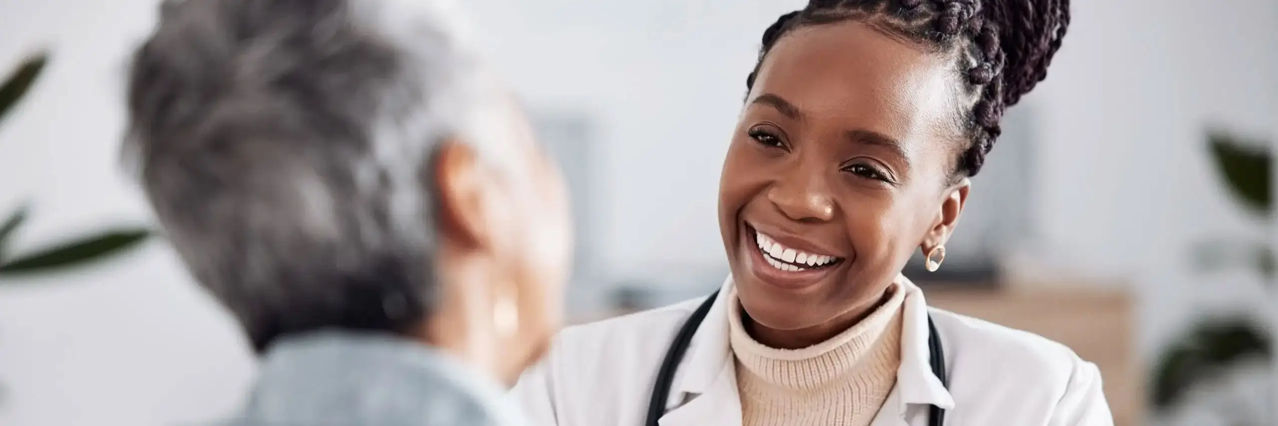 Healthcare provider speaking with an older adult patient during a personalized medical consultation, emphasizing preventive care and patient-focused healthcare.